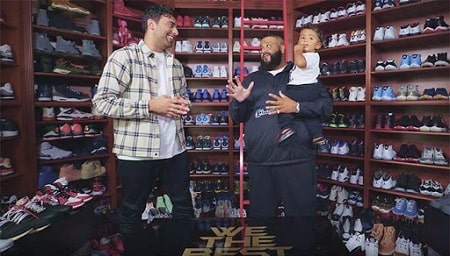 A picture of Asahd Khaled with his father showing their massive shoe collection.